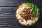 Recipe forÂ dan dan noodlesÂ with minced meat and greens closeup in a plate. horizontal top view